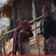 A mother carrying her child beside another woman carrying firewood in a Naga village, Sagaing Region