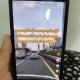 Hand holding a phone showing a TikTok video advertising factory job recruitment with high pay for young workers, illustrating the online job scams targeting unemployed garment workers