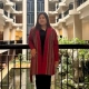 Mu Angela, newly elected chairperson of the Karenni State Consultative Council (KSCC), standing in a traditional red Karenni jacket at a building atrium